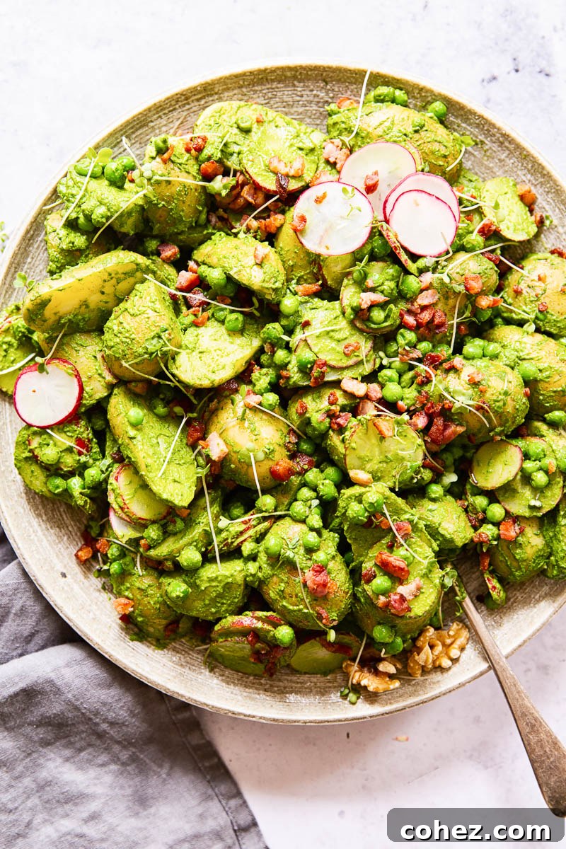 The pesto potato salad artfully arranged on a large serving platter, ready to be enjoyed as a centerpiece dish.