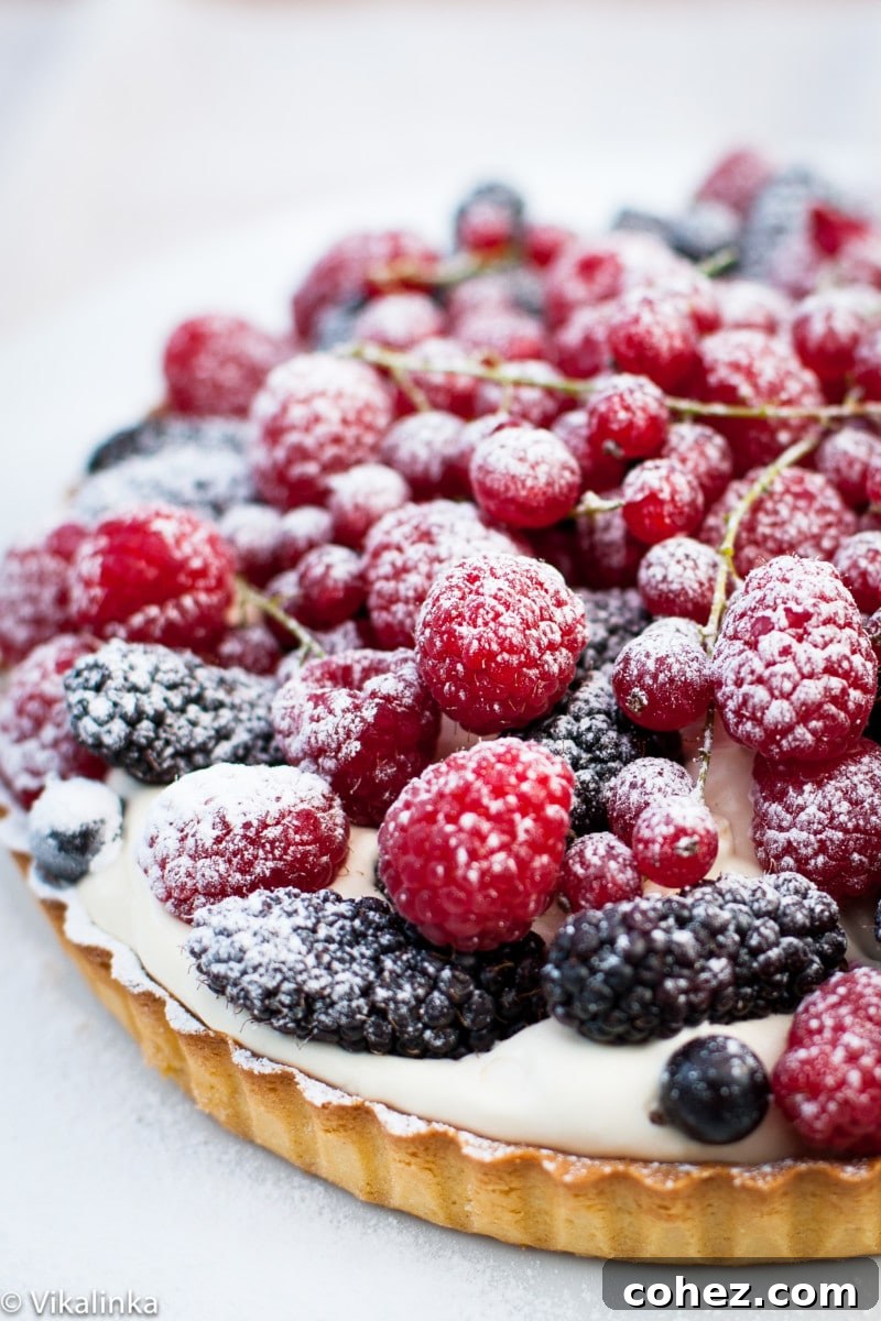 Sweet Summer Berry Bliss 5 Close-up shot of an assortment of fresh berries artfully arranged on top of the tart, showcasing their texture and color.
