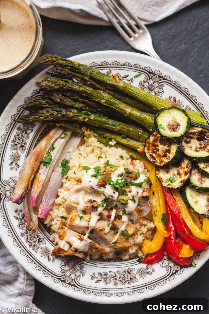 Top down view of couscous bowl showing roasted vegetables and Moroccan chicken