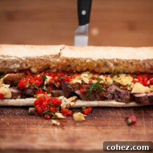 Close up of duck breast sandwich with knife in background