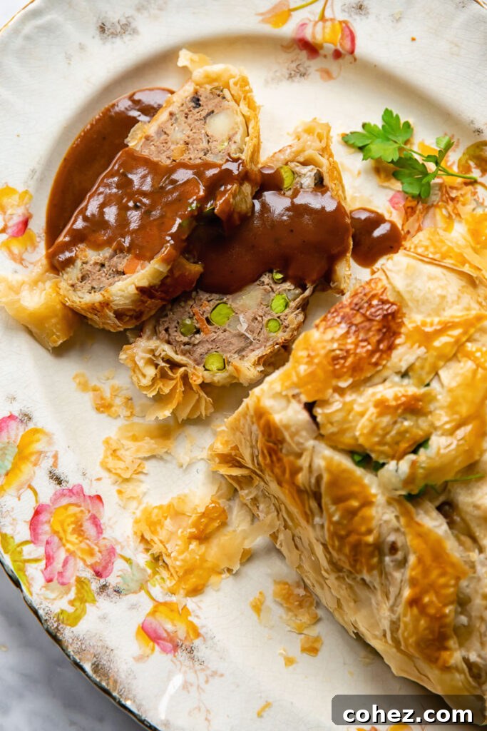 serving platter with pieces of ground beef wellington with gravy