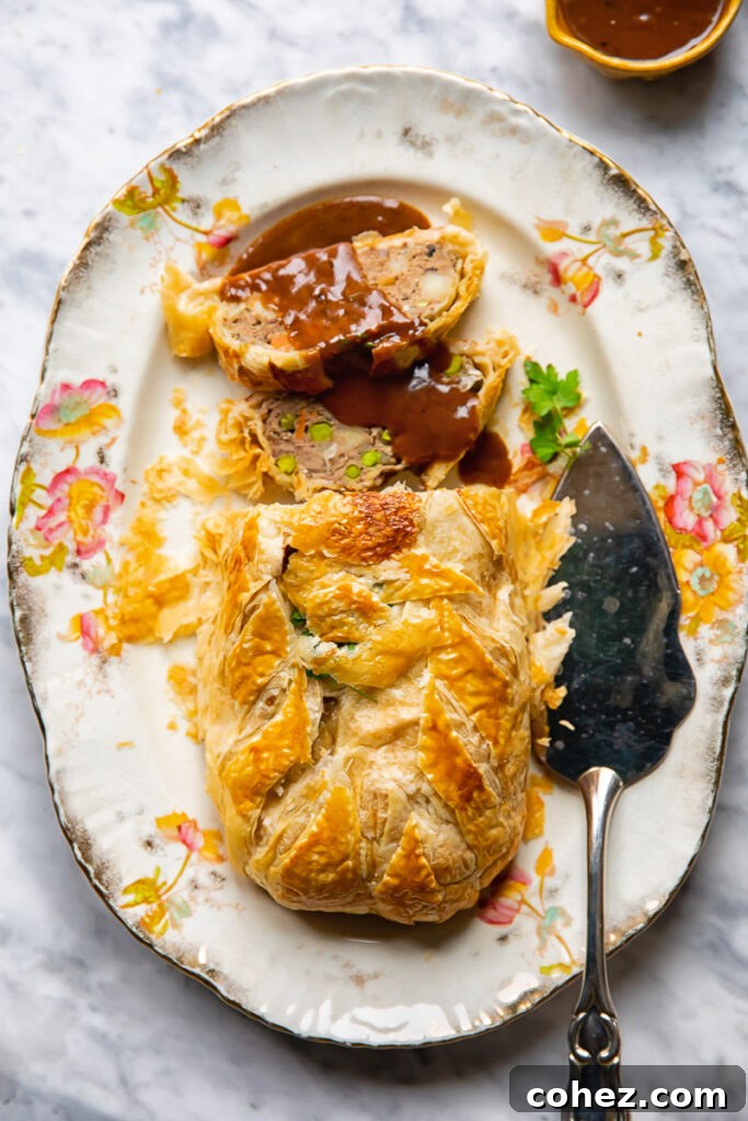 serving platter of wellington and gravy from overhead
