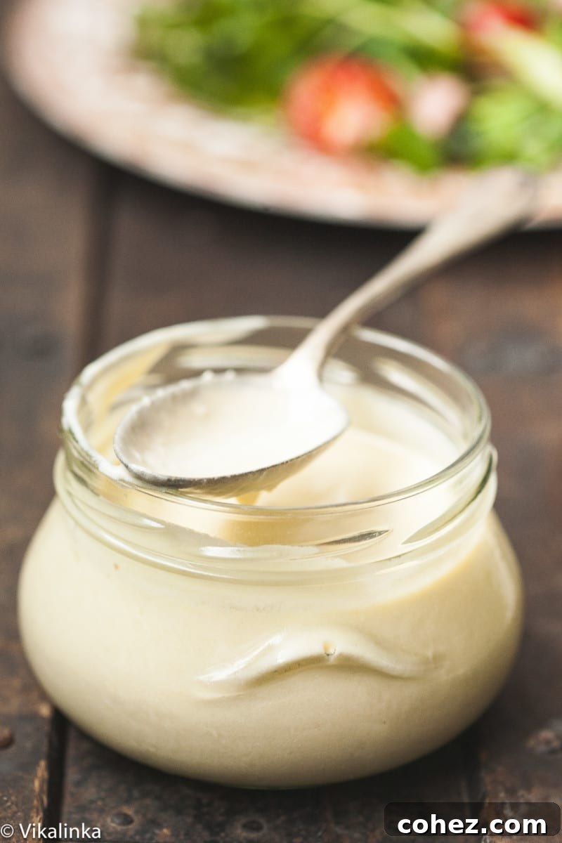 Bold Roast Beef and Watercress Salad with Zesty Horseradish Cream 4 A glass jar filled with creamy horseradish dressing, ready to be served with a salad.