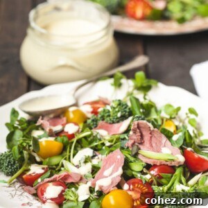 Bold Roast Beef and Watercress Salad with Zesty Horseradish Cream 5 plate of salad with dressing behind in a jar