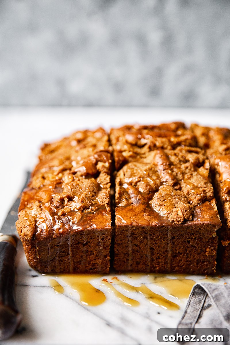 Close-up side view of a slice of apple spice cake revealing its moist texture and streusel