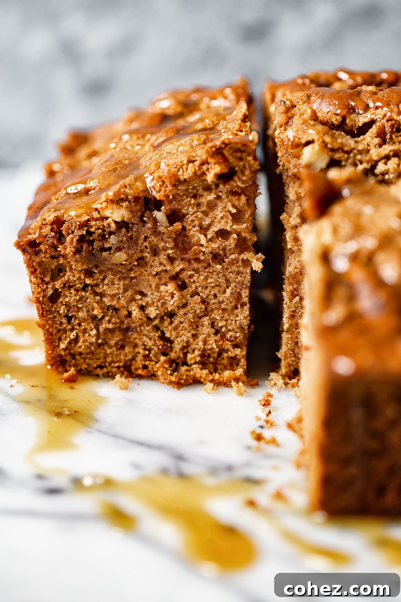 Close-up side view of a single slice of apple spice cake, showing layers