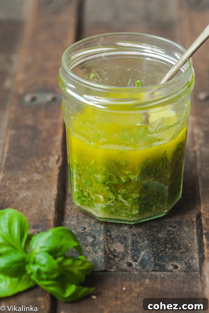 basil vinaigrette in mason jar with a spoon in the jar