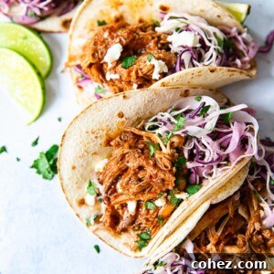 soft corn tacos filled with pulled pork and slaw