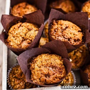 Close up of a freshly baked Toffee Honeycomb Pumpkin Muffin, showcasing its moist texture and golden-brown top with melted honeycomb