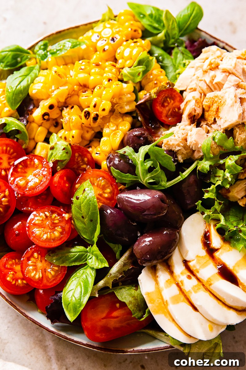 Authentic Italian Salad with cherry tomatoes, tuna, corn, olives, and fresh mozzarella