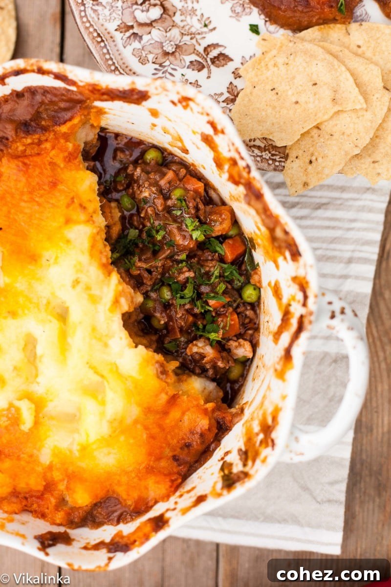 Top down view of a cooked Indian Spiced Shepherd's Pie, showing the golden mashed potato crust and rich filling