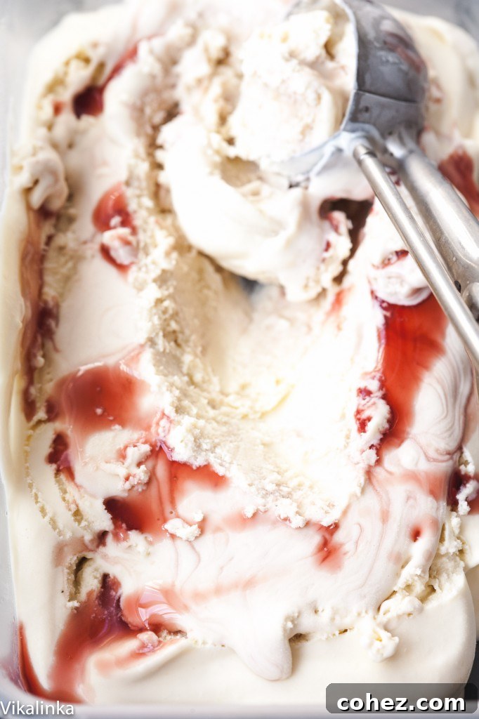 Close-up shot of the vibrant red and dark purple Amarena cherry swirls in creamy gelato.