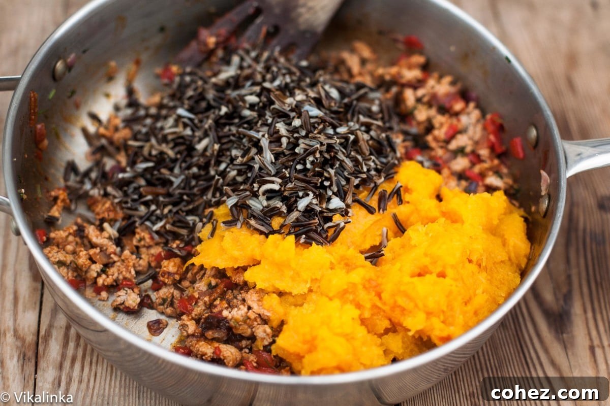 A close-up shot of the savory filling ingredients mixed in a bowl, featuring ground turkey, wild rice, and vegetables.