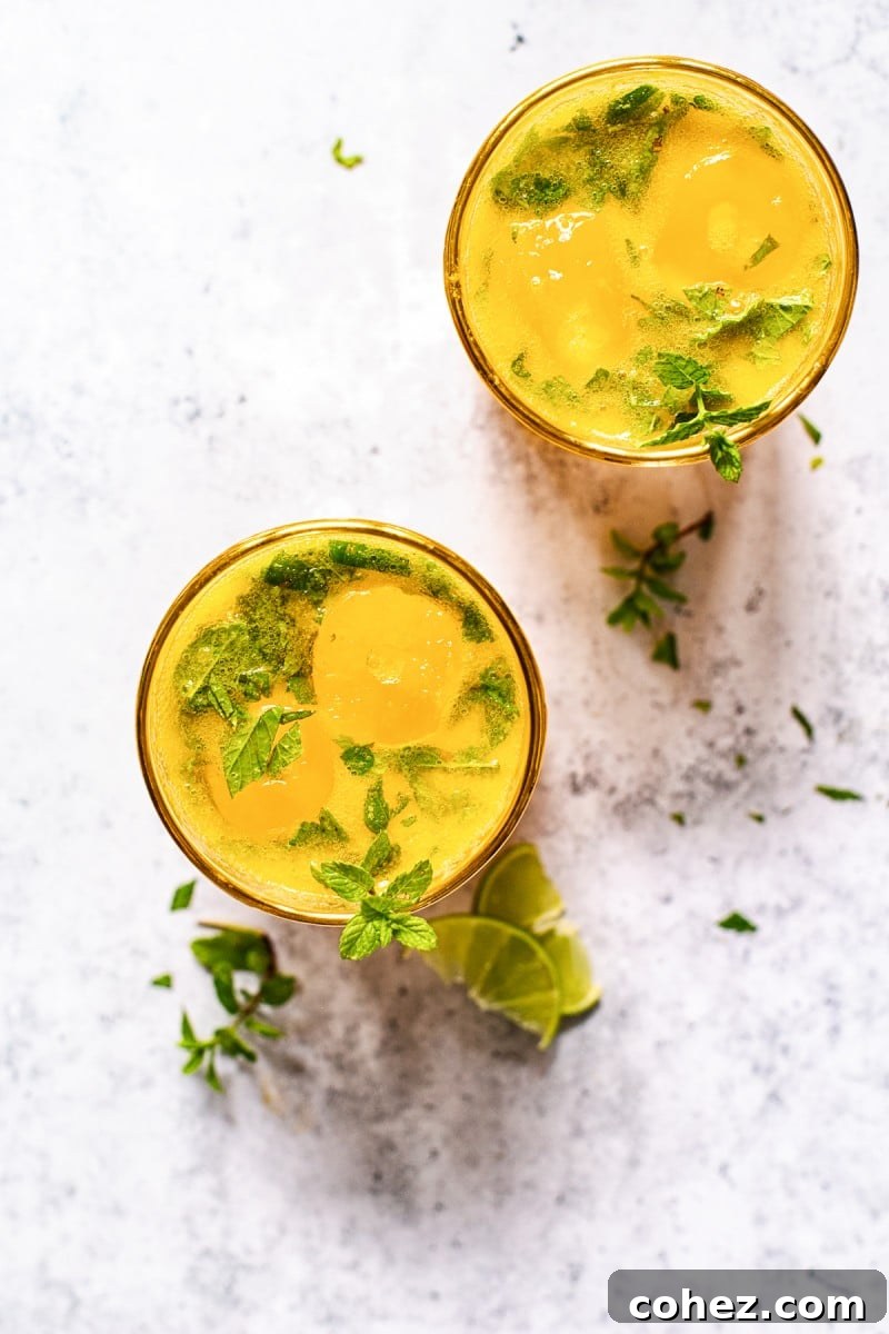 Ingredients for a mango mojito laid out: fresh mango, limes, mint, rum, and simple syrup. #mojitoingredients #cocktailrecipe