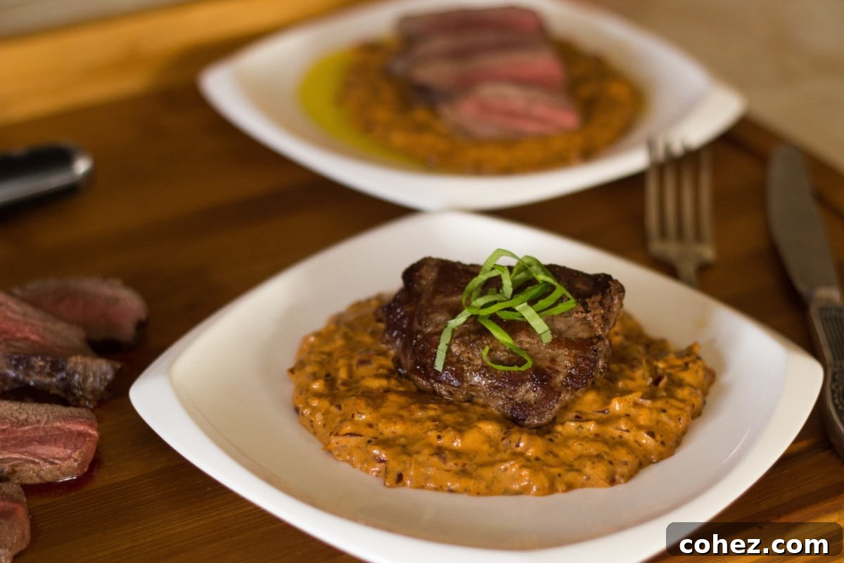 Pan-seared venison steak diane with creamy sauce on a white plate