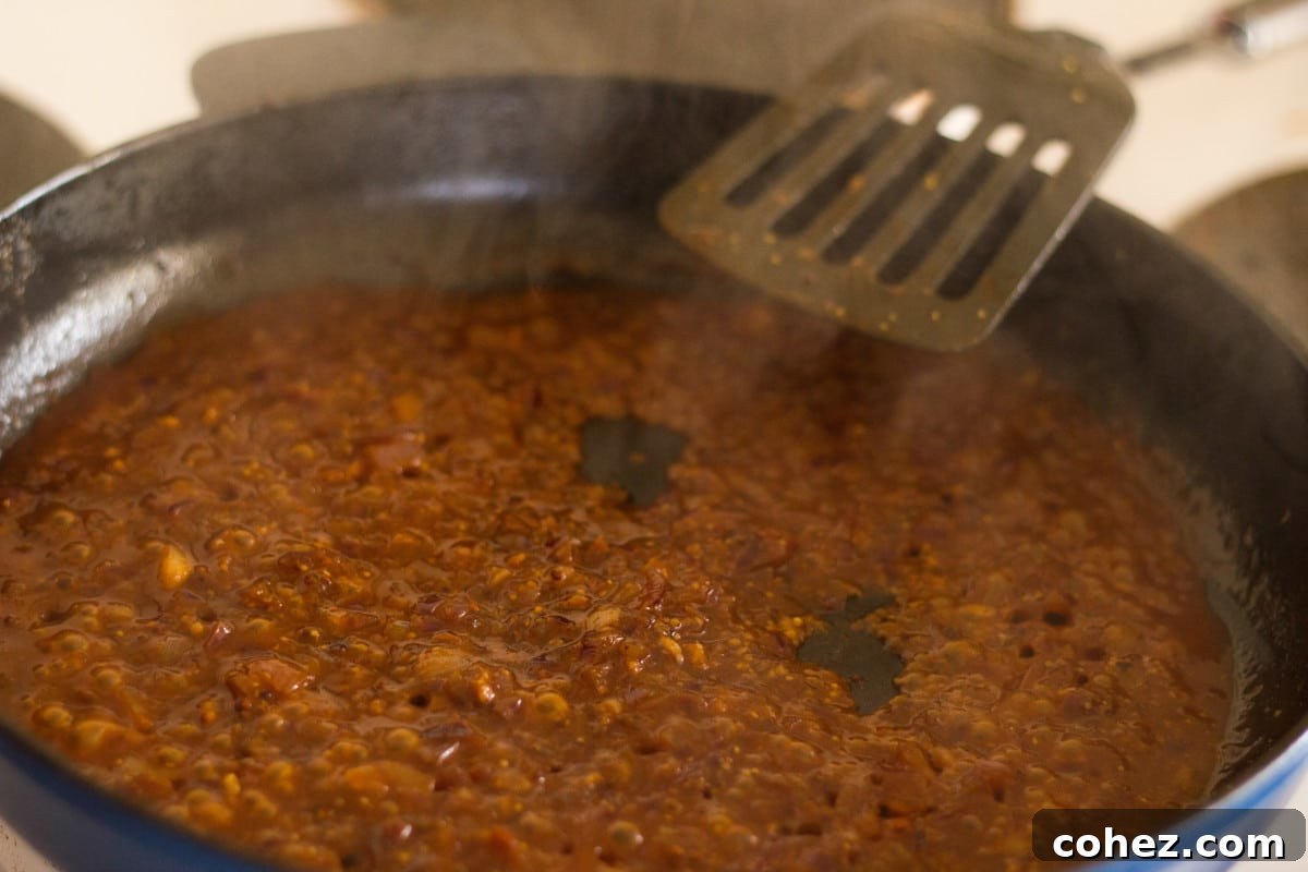 Diane sauce simmering and thickening in a pan