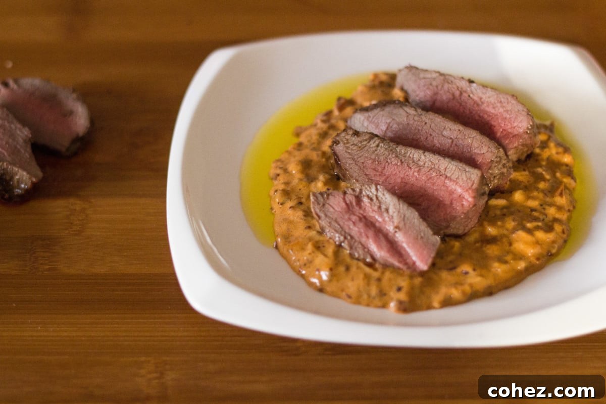 Top-down view of sliced venison steak medallions with Diane sauce