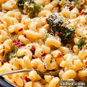 Sun-Kissed Tomato and Broccoli Pasta with Parmesan 6 A close-up of the finished broccoli and sun-dried tomato pasta in a pan, garnished and ready to serve.