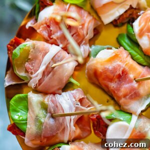 close up of prosciutto caprese bites on a shiny pattern