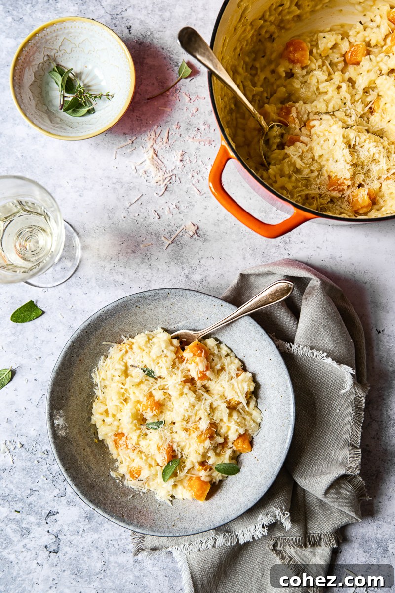 Top-down view of Butternut Squash Risotto in a bowl, garnished with fresh sage leaves.