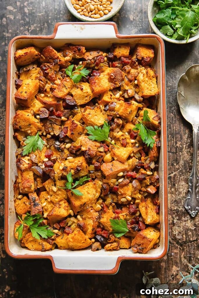 Top down shot of chorizo stuffing in a baking dish topped with fresh parsley, highlighting its golden crust and vibrant ingredients.