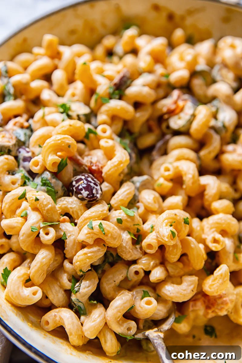 Pan with the Mediterranean pasta with zucchini, creamy sauce, and fresh herbs.