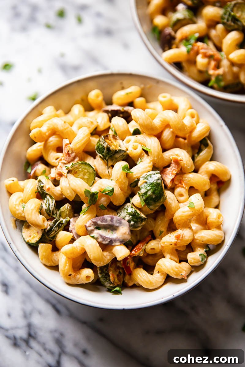 Top-down view of a vibrant bowl of zucchini pasta, ready to be served.