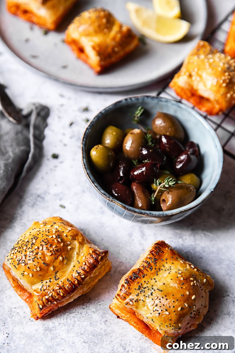 Table spread with chorizo sausage rolls and olives, ready for a party