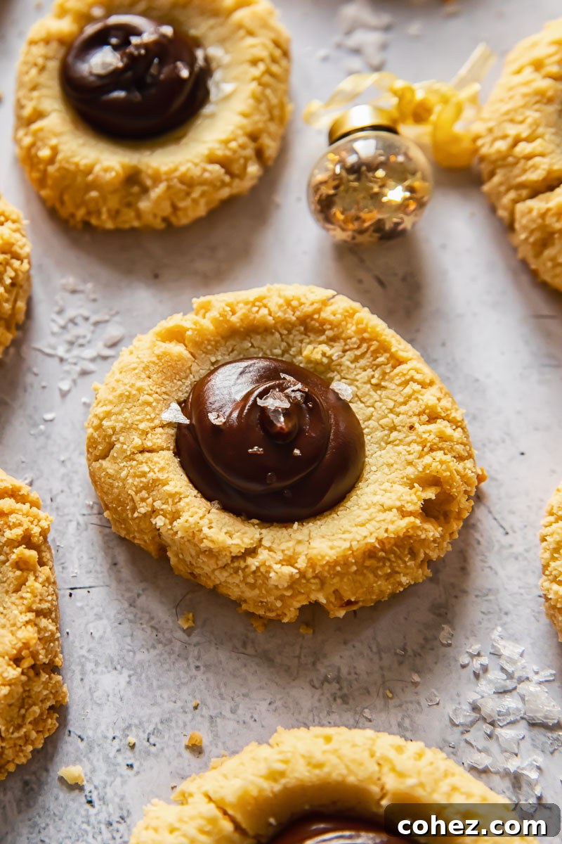 Chocolate Almond Thumbprint Cookies 3 Close-up of freshly baked almond thumbprint cookies, showing their perfect indentations and inviting texture, ready for filling.