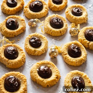 Almond thumbprint cookies with dark chocolate and sea salt, ready to be enjoyed.