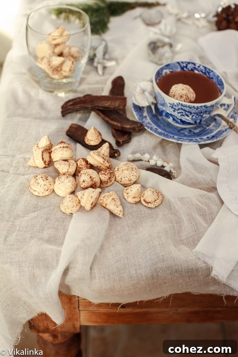Italian Hot Chocolate artfully arranged next to delicate meringues and a sprinkle of cinnamon, evoking warmth and festive spirit.