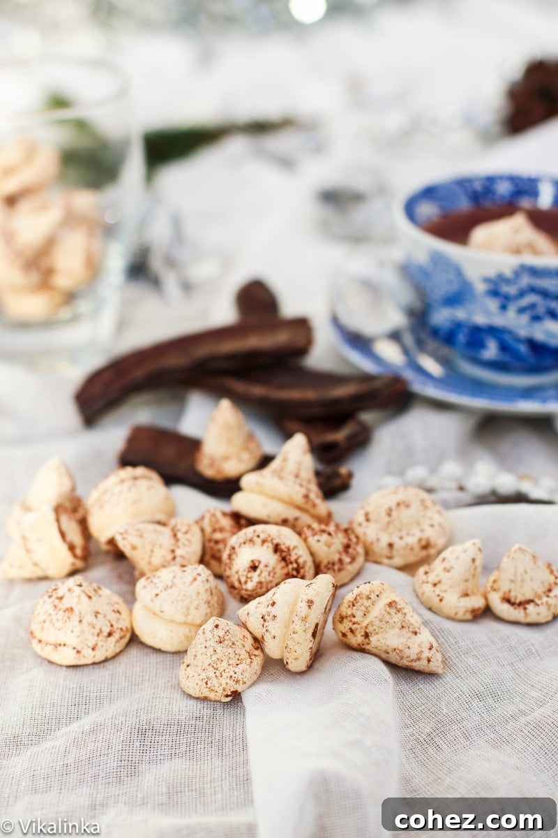 A steaming cup of rich Italian Hot Chocolate, adorned with a fluffy, white meringue kiss, promises a delightful treat.