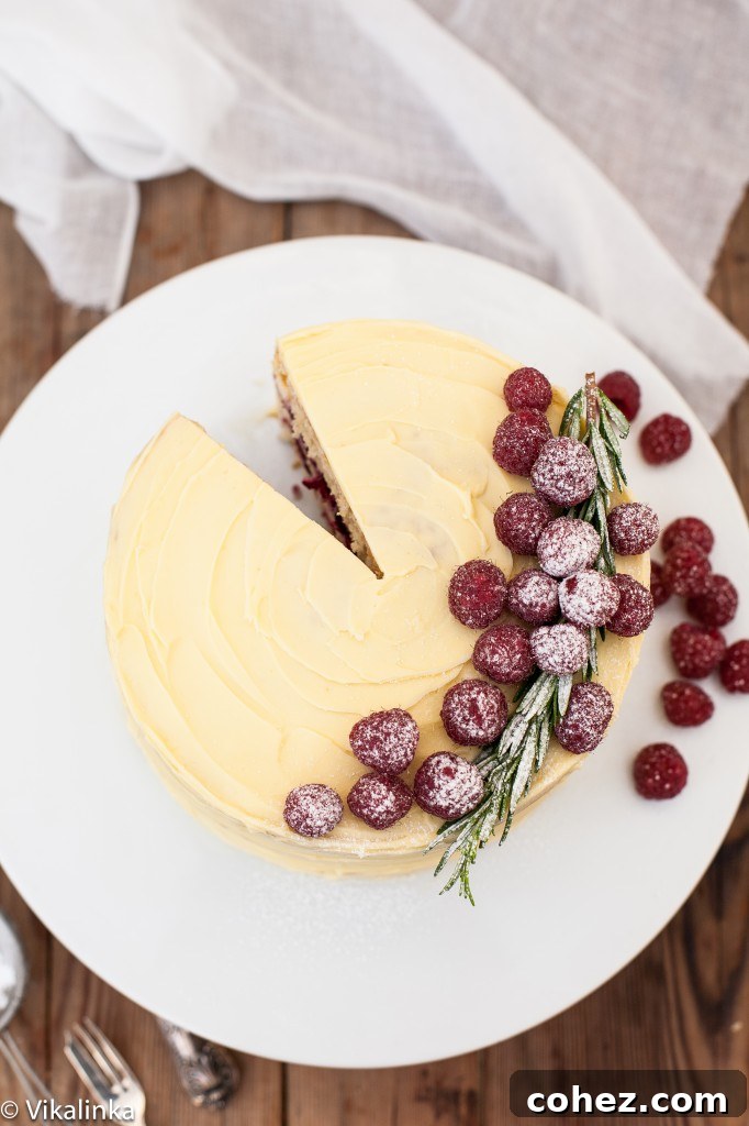 Top down view of the frostbitten raspberry cake with a slice removed