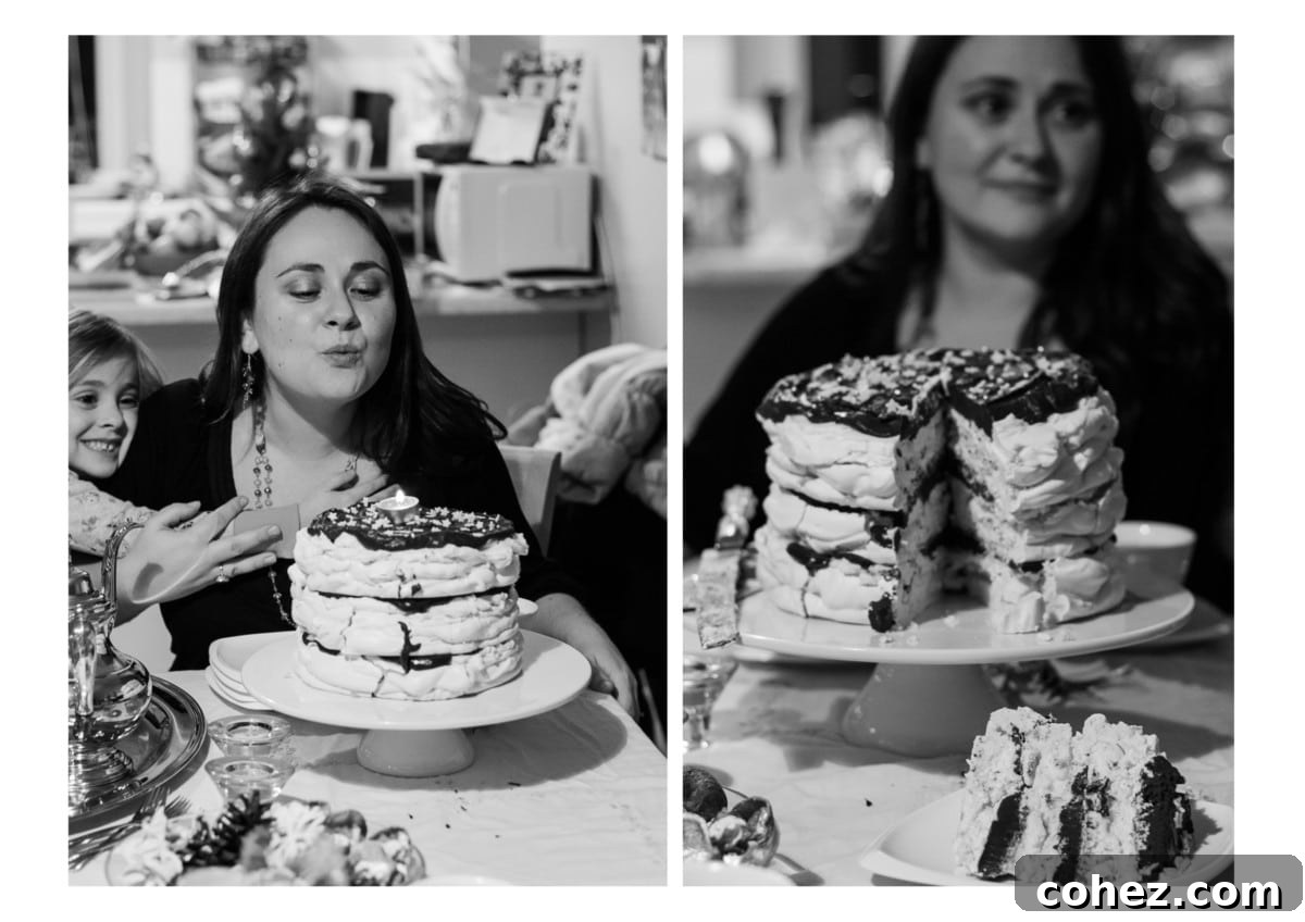 A woman standing proudly behind a beautifully cut slice of Meringue Mascarpone Cake, showcasing its distinct inner layers and the contrast between crispy meringue and soft filling.
