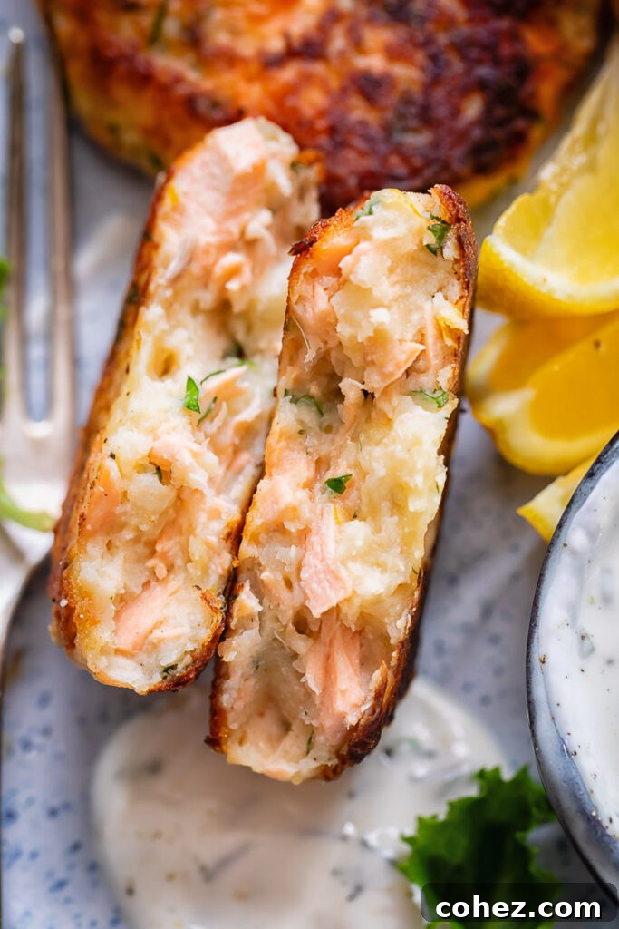 Close up shot of salmon cakes cross section with fluffy potato inside