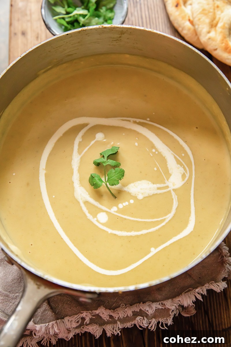 Velvety Cauliflower Cheese Soup 3 Top down view of creamy cauliflower soup simmering in a pot