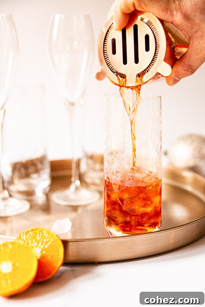 Negroni Sparkle 4 Negroni pouring from shaker into a glass