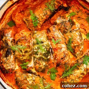 cabbage rolls in creamy tomato sauce in orange pot