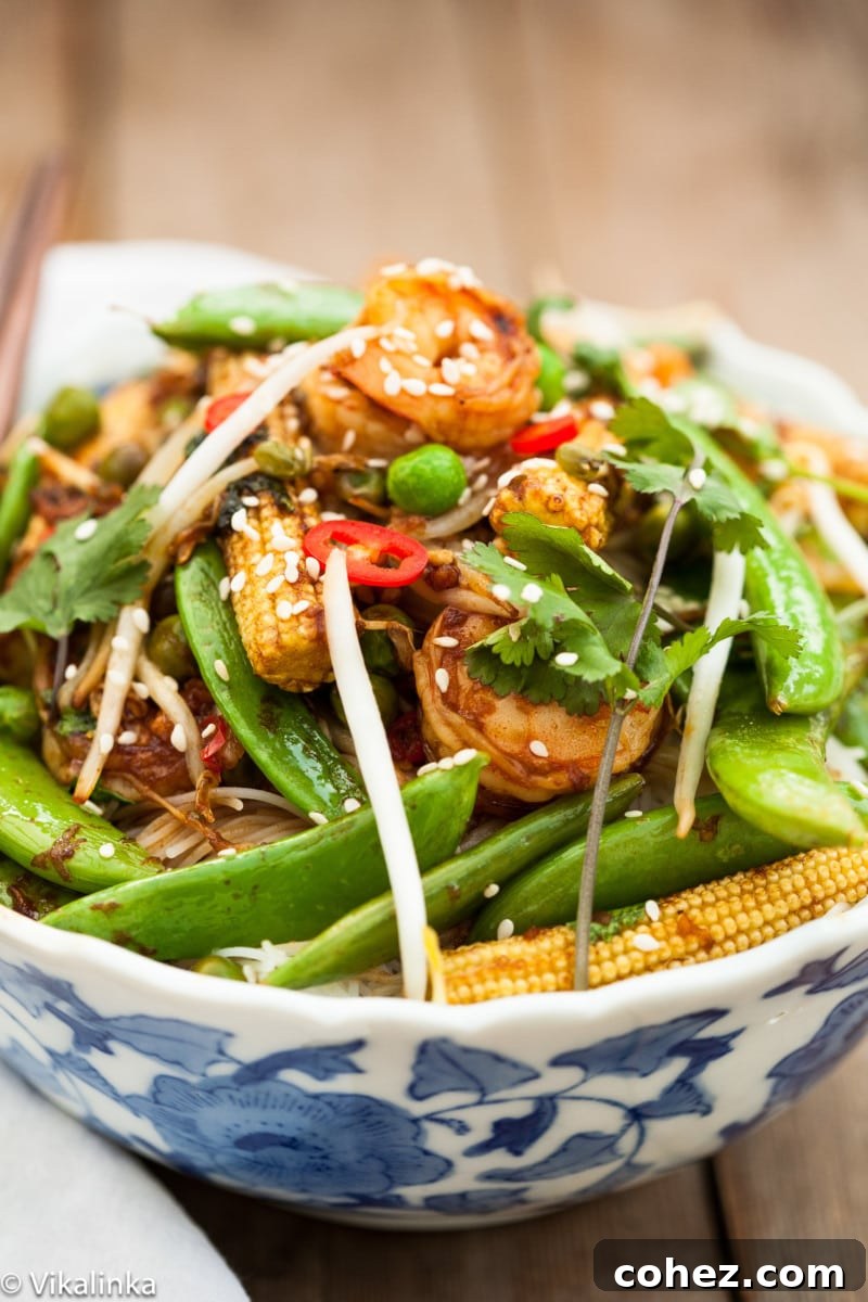 Close-up of freshly cooked sesame shrimp stir fry with various vegetables.