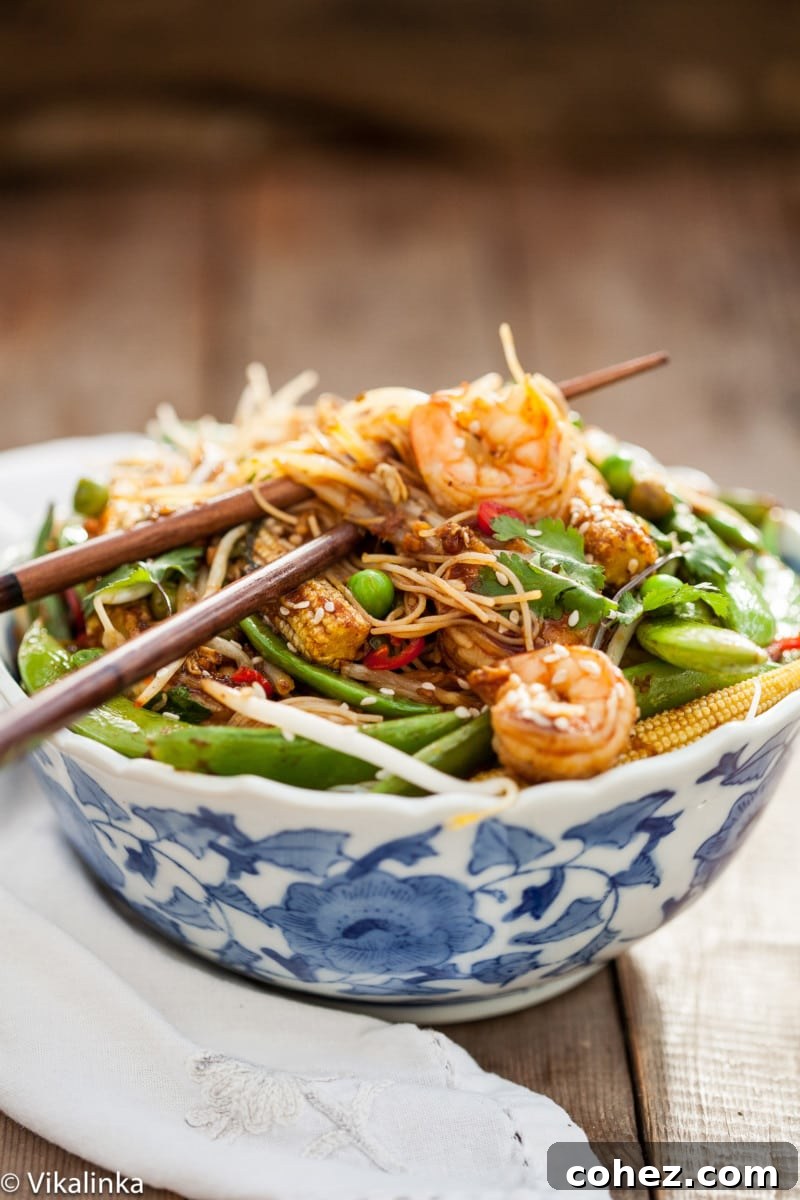 Shrimp Stir Fry served beautifully in a white and blue bowl.