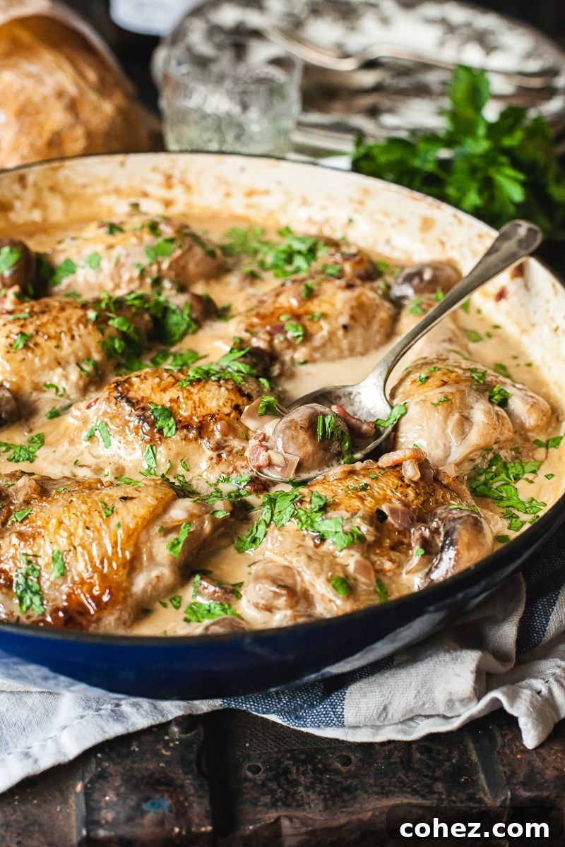Savory White Wine Chicken 5 Coq au Vin Blanc in a pan with serving spoon