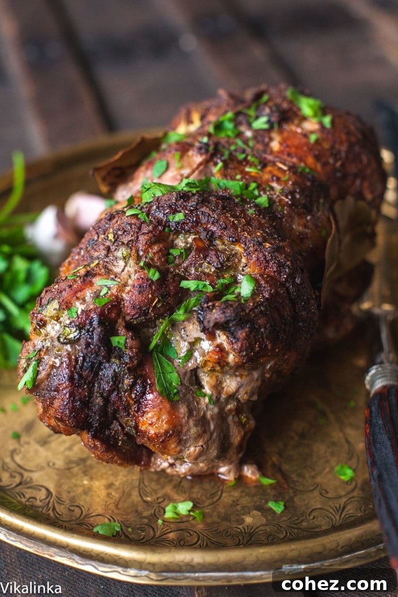 Aromatic spiced pork roast on a platter, ready to be served at a holiday gathering.