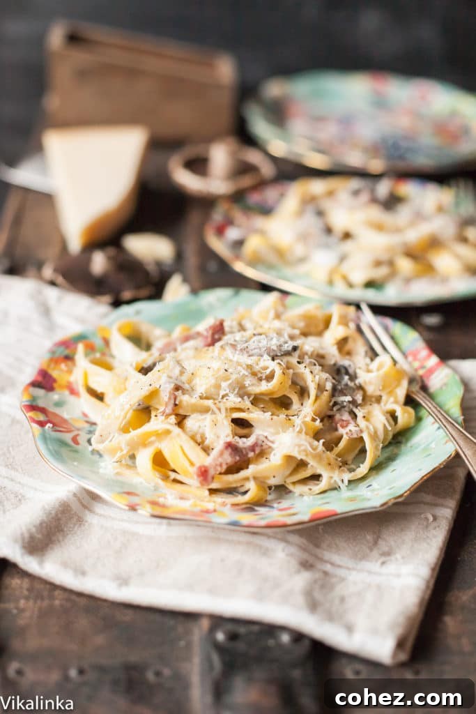 An overhead shot of creamy pasta with bacon and Portobello mushrooms, presented beautifully for a date night meal.