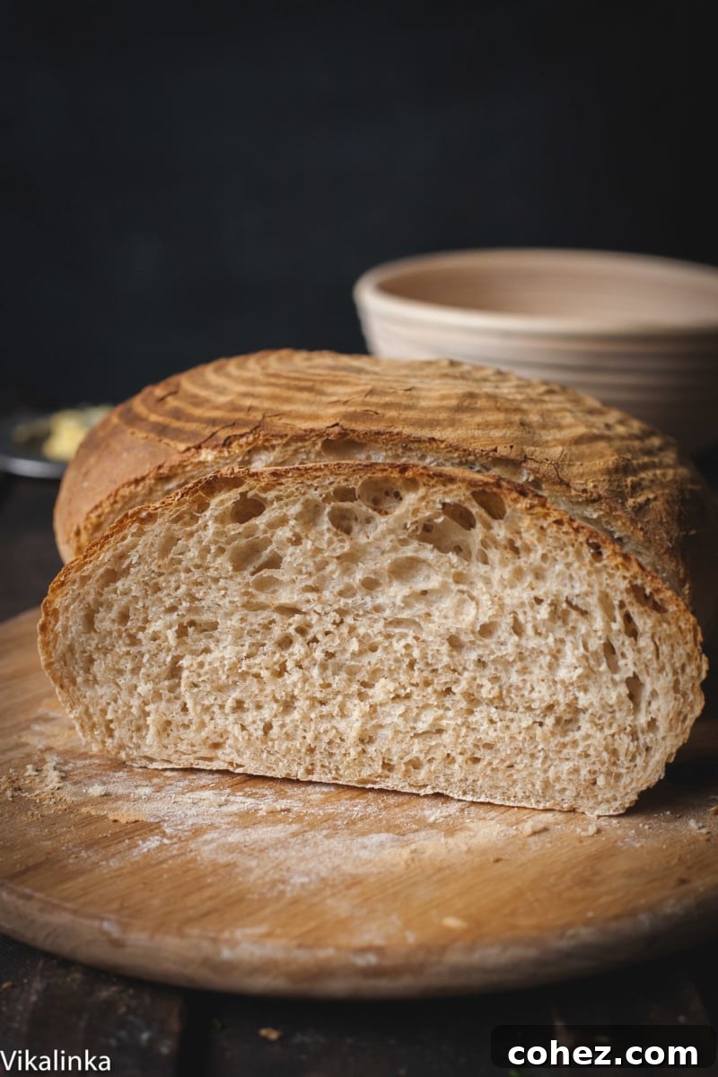 Several thick slices of Rosemary Spelt Bread arranged on a wooden cutting board, inviting for a taste.