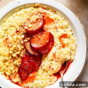 Millet porridge in a white bowl, generously topped with cooked plums, crunchy walnuts, and nutritious chia seeds.