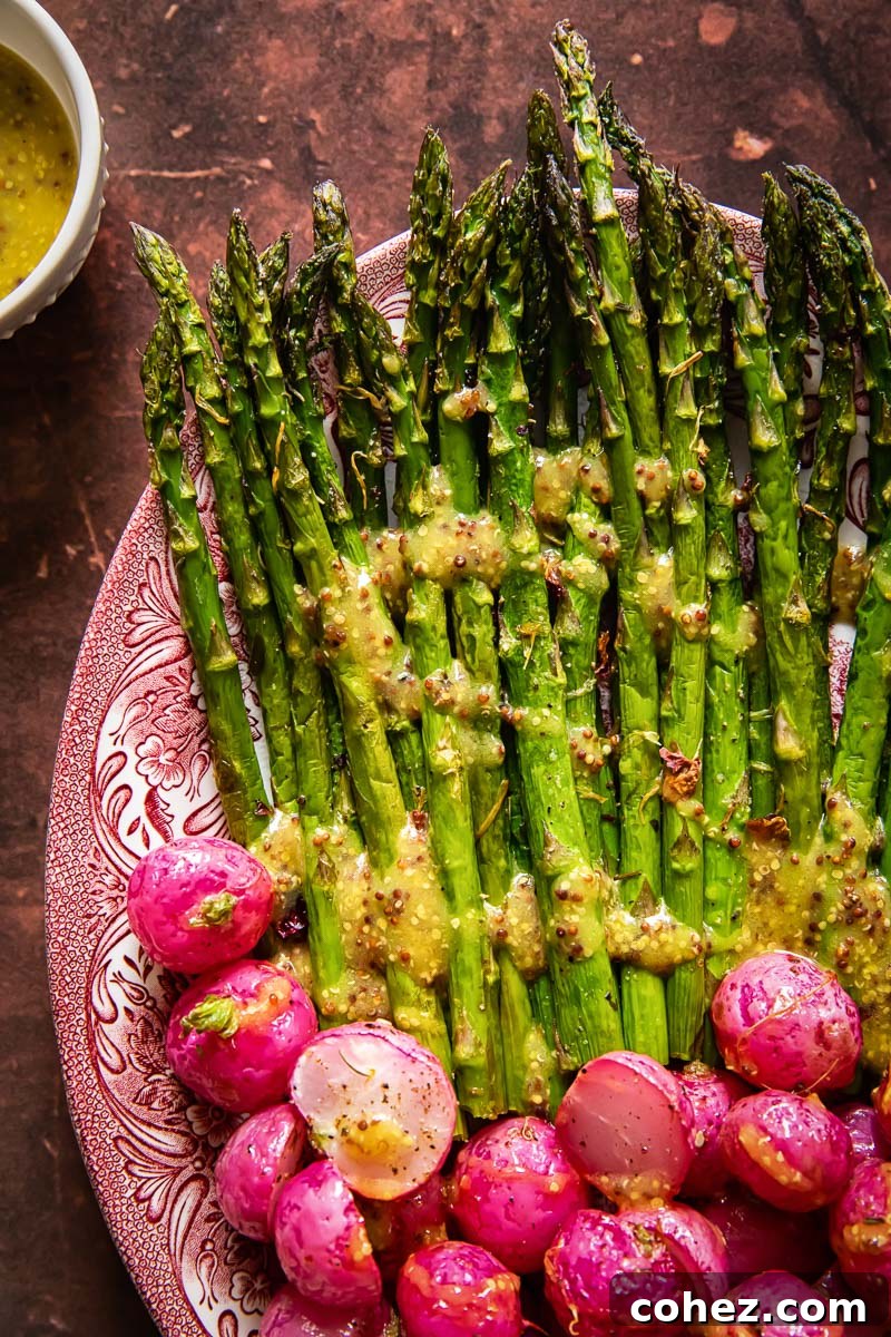 A beautifully arranged serving platter showcasing a generous portion of roasted radishes and asparagus, ready to be enjoyed.
