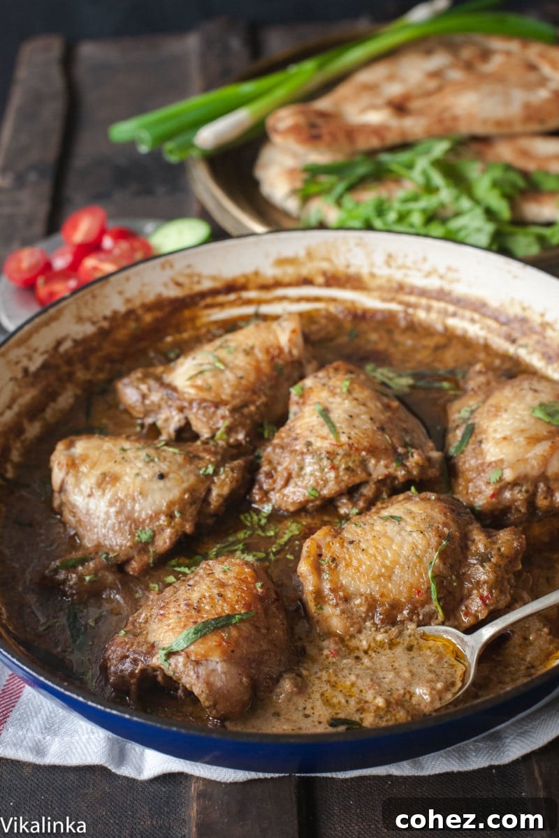 Close up of chicken in garlic walnut sauce, showcasing the rich texture and vibrant colors