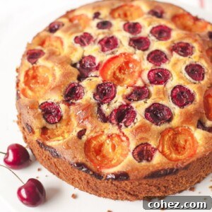 Cake on a stand with two cherries