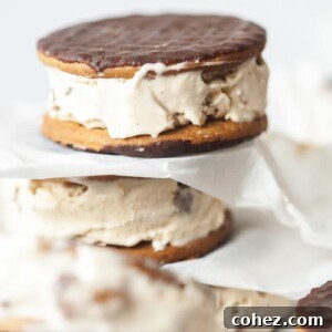 Prepared cappuccino Daim ice cream sandwiches neatly stacked with parchment paper, ready to be enjoyed.