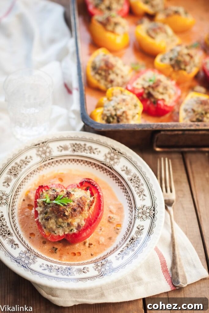 Freshly baked lean stuffed peppers, vibrant and appealing, nestled in a creamy tomato sauce.